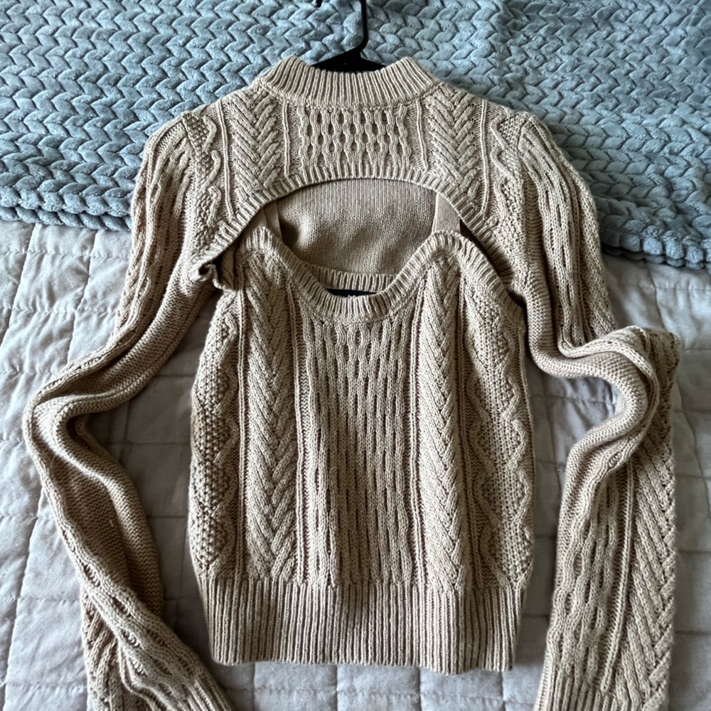 Beige sweater tank with crop long sleeves.